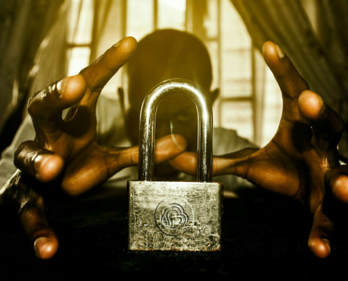 Man trying to open a padlock with his mind